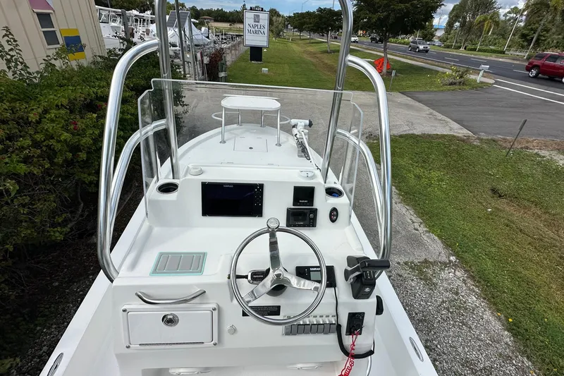 Slide: The Image of 2020 Shallow Sport 24 Classic boat dashboard with steering wheel and navigation equipment. - 13