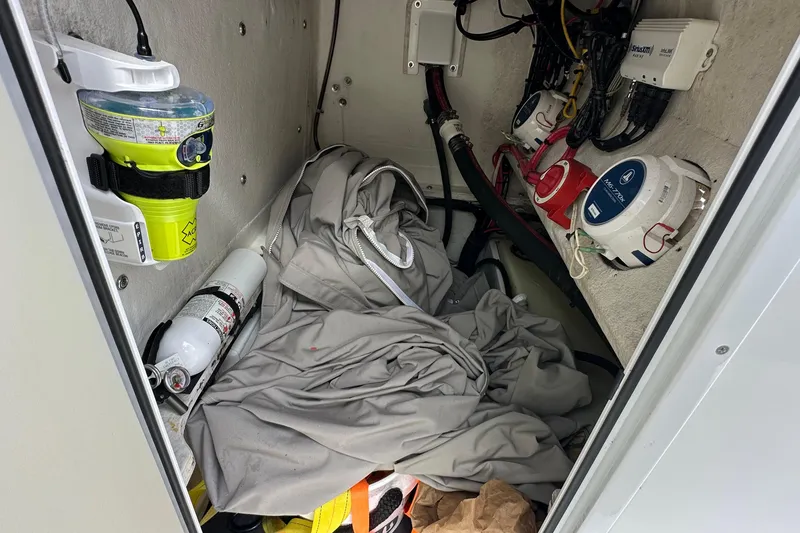 Slide: The Image of Storage compartment of a 2020 Shallow Sport 24 Classic boat with equipment and wiring. - 14