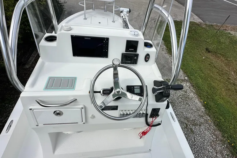 Slide: The Image of 2020 Shallow Sport 24 Classic boat console with steering wheel and navigation equipment. - 5