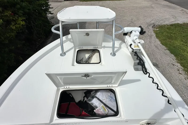 Slide: The Image of 2020 Shallow Sport 24 Classic boat deck with open storage compartments and trolling motor. - 8