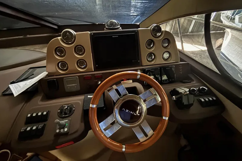 Slide: The Image of Cockpit of 2009 Azimut 43 yacht with wooden steering wheel and control panel. - 3