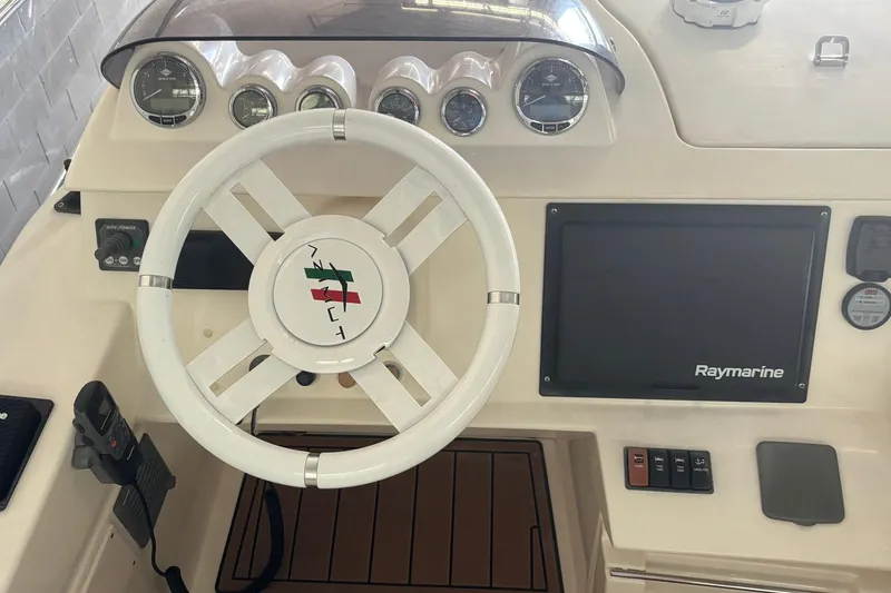 Slide: The Image of Cockpit of 2009 Azimut 43 yacht with steering wheel and Raymarine navigation system. - 4