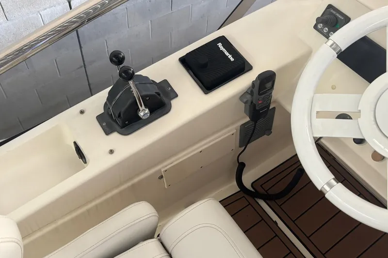 Slide: The Image of 2009 Azimut 43 yacht helm with steering wheel, throttle controls, and navigation equipment. - 5