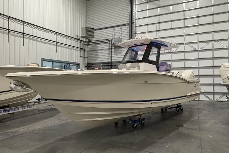 The Image of 2026 Scout 288 LXF boat in a showroom, showcasing sleek design and modern features. - 0