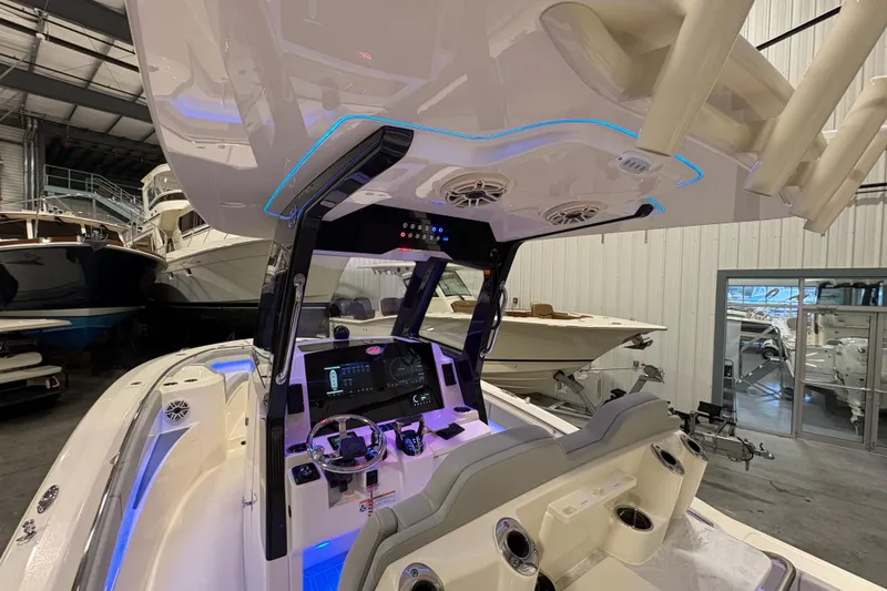 Slide: The Image of 2026 Scout 288 LXF boat interior with advanced dashboard and seating in a showroom. - 12