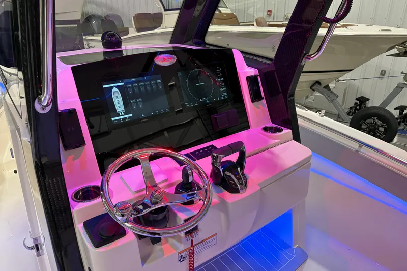 Slide: The Image of 2026 Scout 288 LXF boat dashboard with modern controls and illuminated display. - 13