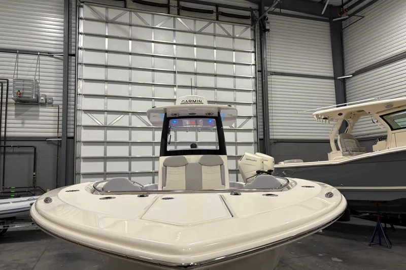 Slide: The Image of 2026 Scout 288 LXF boat in a showroom, showcasing sleek design and modern features. - 2