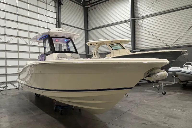 Slide: The Image of 2026 Scout 288 LXF boat in a spacious indoor storage facility. - 3