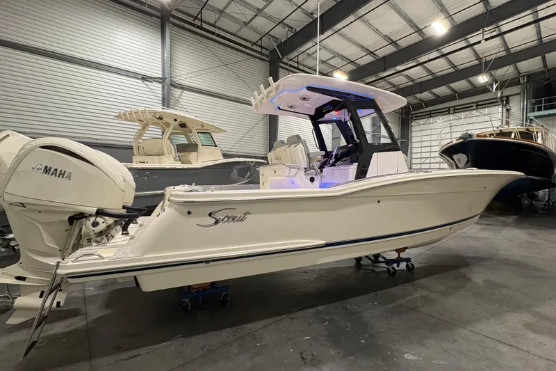 Slide: The Image of 2026 Scout 288 LXF boat in showroom, featuring Yamaha engine, sleek design. - 4