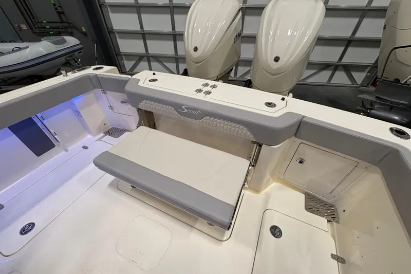 Slide: The Image of 2026 Scout 288 LXF boat interior with seating and dual outboard motors. - 7