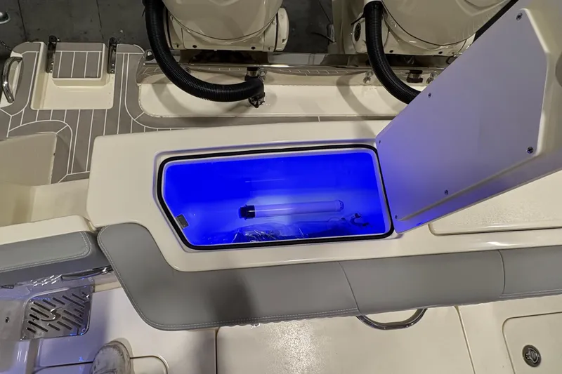 Slide: The Image of 2026 Scout 288 LXF boat with illuminated storage compartment and sleek interior design. - 8