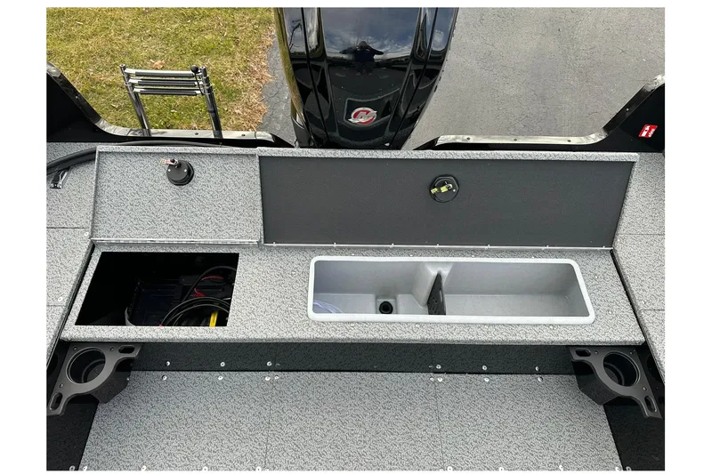 Slide: The Image of 2026 Lund 1800 Explorer SS boat interior with storage compartments and motor view. - 11