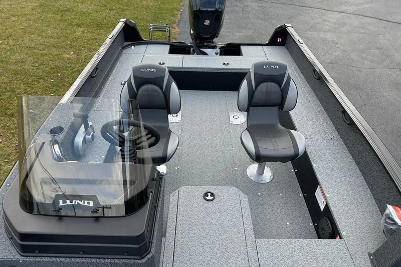Slide: The Image of 2026 Lund 1800 Explorer SS boat interior with two seats and steering console. - 12