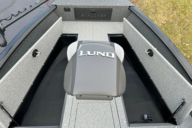 Slide: The Image of 2026 Lund 1800 Explorer SS boat interior with branded seat and storage compartments. - 19