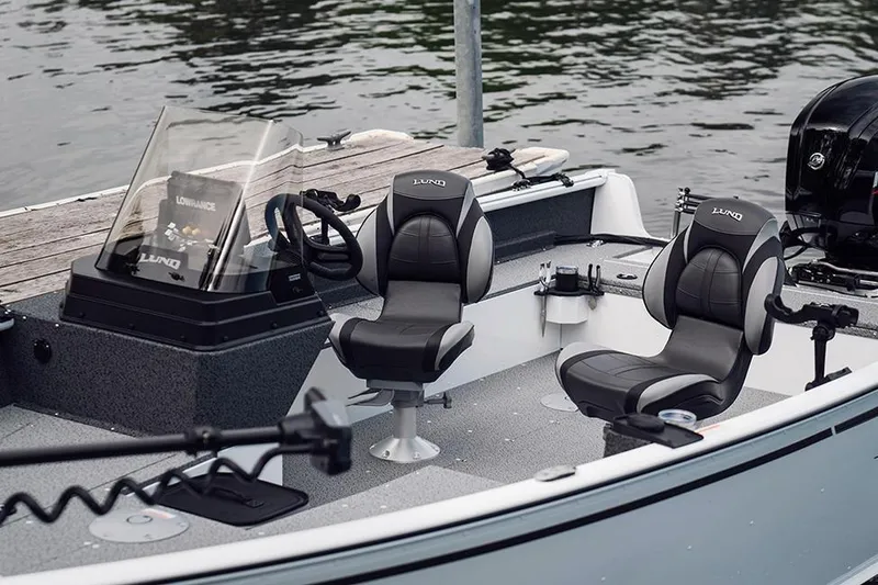 Slide: The Image of 2026 Lund 1800 Explorer SS boat with powerful outboard motor at dealership. - 3