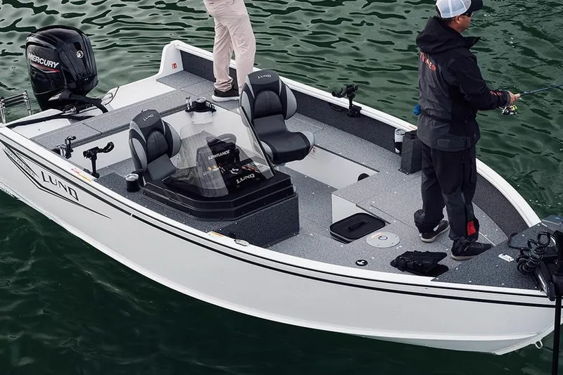 Slide: The Image of 2026 Lund 1800 Explorer SS boat on trailer, black exterior, Mercury Pro XS engine. - 4