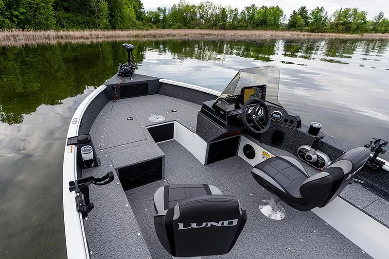 Slide: The Image of 2026 Lund 1800 Explorer SS boat with Mercury Pro XS engine, parked outside dealership. - 5