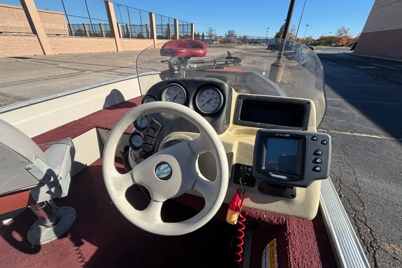 Slide: The Image of 2002 Sea Nymph FM 165 S boat dashboard with steering wheel and navigation system. - 10