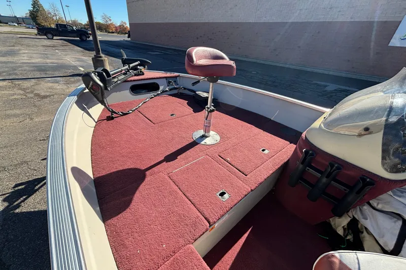 Slide: The Image of 2002 Sea Nymph FM 165 S boat interior with red carpet and fishing seat. - 6