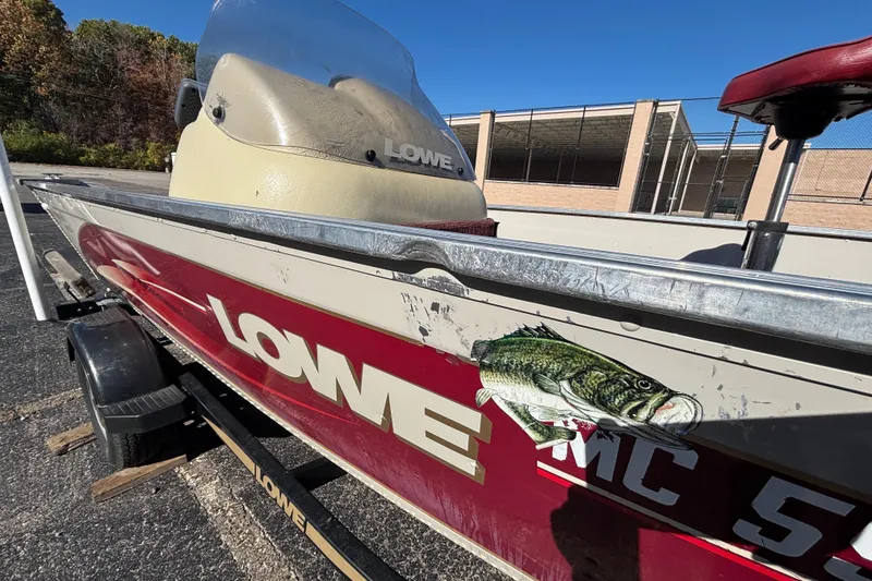 Slide: The Image of 2002 Sea Nymph FM 165 S fishing boat with fish decal and Lowe branding. - 9