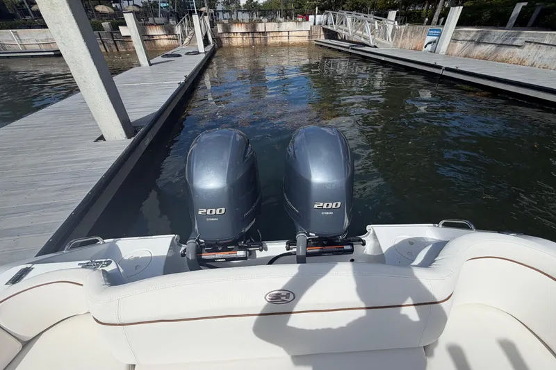Slide: The Image of 2022 Sea Hunt Ultra 275 SE with twin Yamaha 200 engines at a dock. - 16