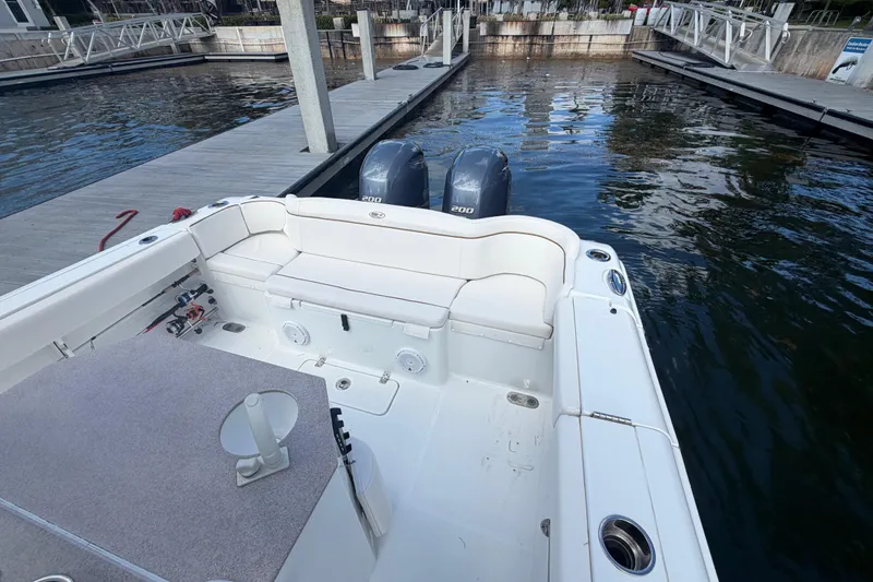 Slide: The Image of 2022 Sea Hunt Ultra 275 SE boat with dual engines docked at marina. - 19
