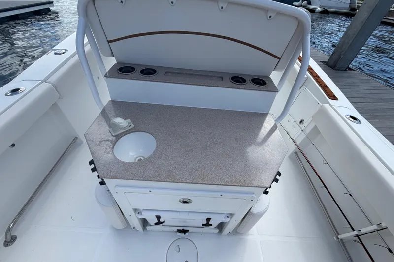 Slide: The Image of 2022 Sea Hunt Ultra 275 SE boat interior with sink and storage area. - 20