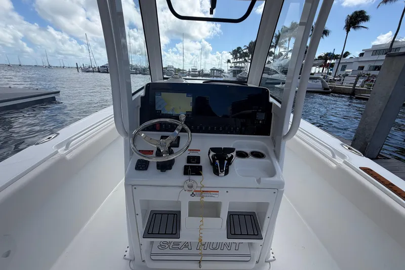 Slide: The Image of 2022 Sea Hunt Ultra 275 SE boat cockpit with steering wheel and navigation system. - 28