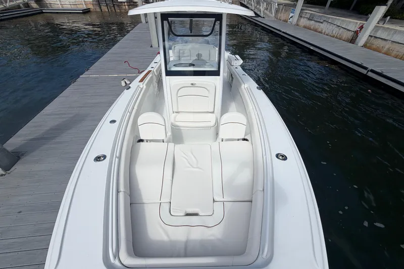 Slide: The Image of 2022 Sea Hunt Ultra 275 SE boat docked, featuring spacious seating and sleek design. - 31