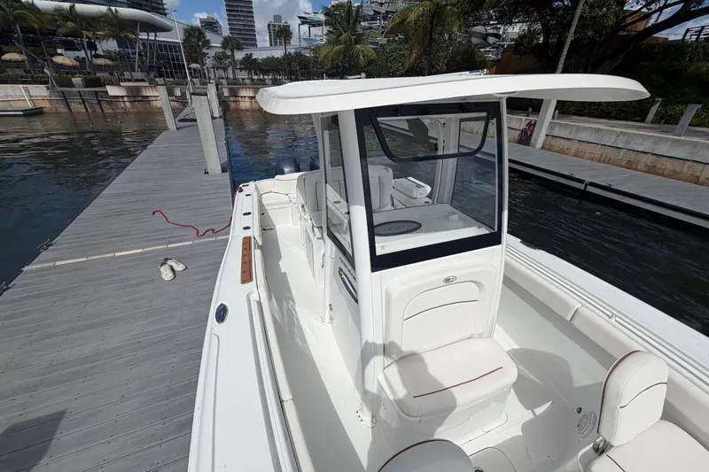 Slide: The Image of 2022 Sea Hunt Ultra 275 SE boat docked at marina, featuring sleek design and spacious interior. - 41