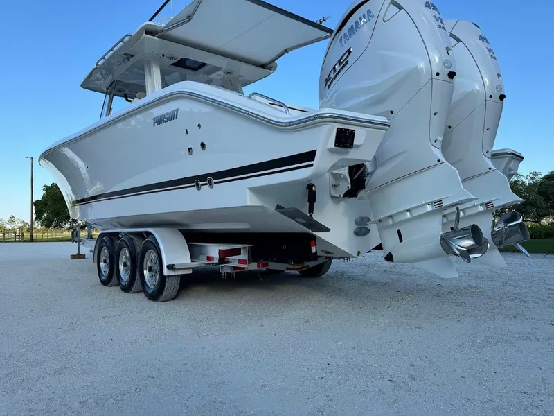 Slide: The Image of 2024 Pursuit S 358 Sport boat on trailer with dual outboard engines. - 12