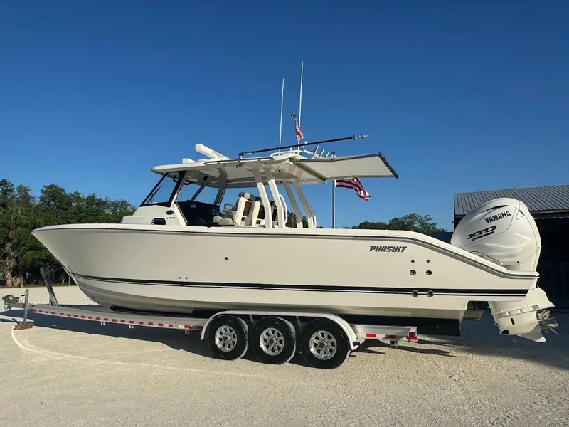 Slide: The Image of 2024 Pursuit S 358 Sport boat on trailer, side view, clear sky background. - 13
