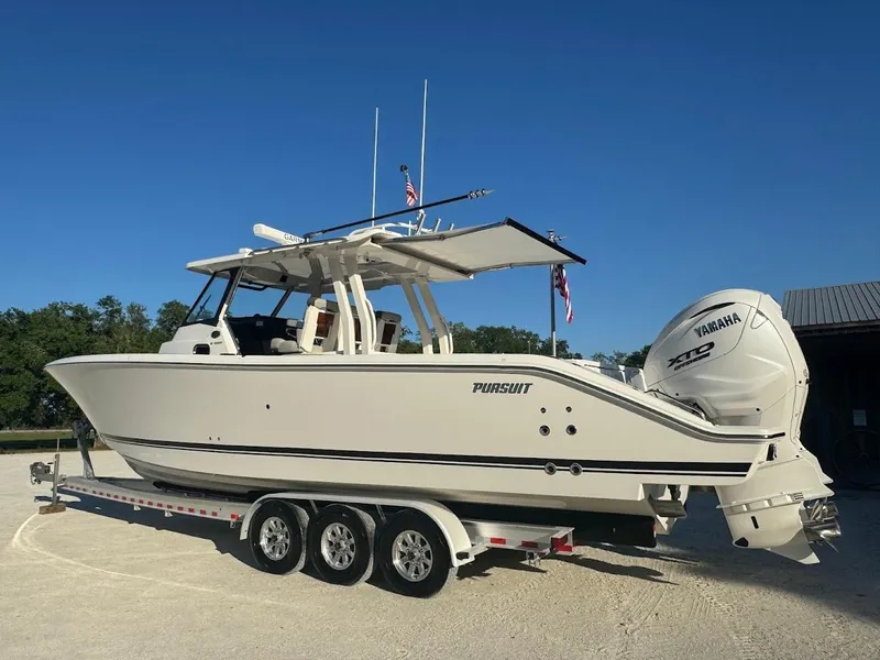 Slide: The Image of 2024 Pursuit S 358 Sport boat on trailer, featuring twin Yamaha engines. - 14
