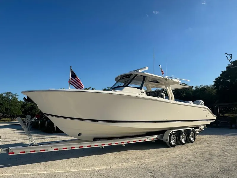 Slide: The Image of 2024 Pursuit S 358 Sport boat on trailer under clear blue sky. - 18