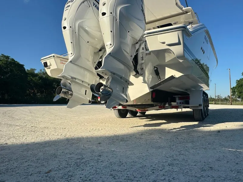 Slide: The Image of 2024 Pursuit S 358 Sport boat with dual outboard engines on a trailer. - 23