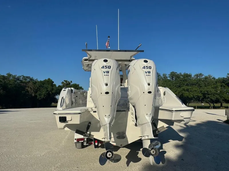 Slide: The Image of 2024 Pursuit S 358 Sport boat with dual 450 V8 engines, parked outdoors. - 24