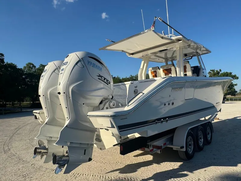 Slide: The Image of 2024 Pursuit S 358 Sport boat with dual Yamaha outboard engines on a trailer. - 25
