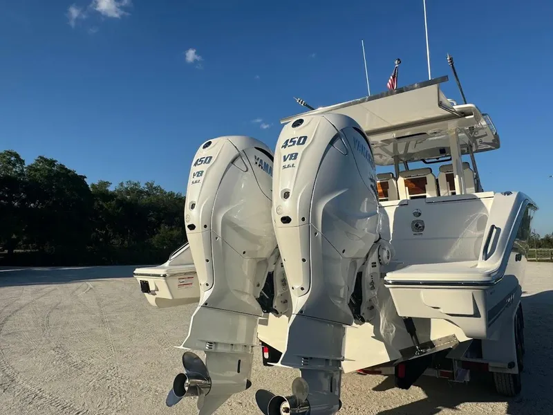 Slide: The Image of 2024 Pursuit S 358 Sport boat with twin 450 V8 engines, parked on a sunny day. - 26