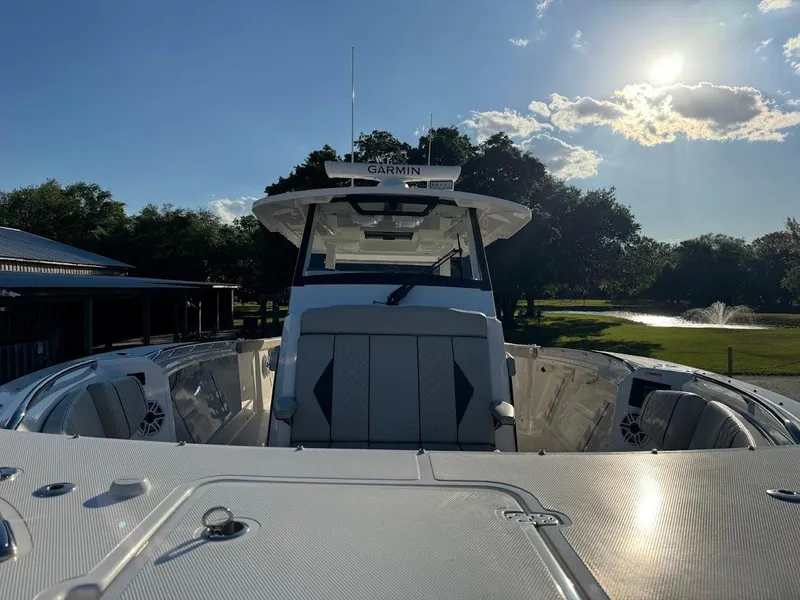 Slide: The Image of 2024 Pursuit S 358 Sport boat with sleek design, docked under a sunny sky. - 27