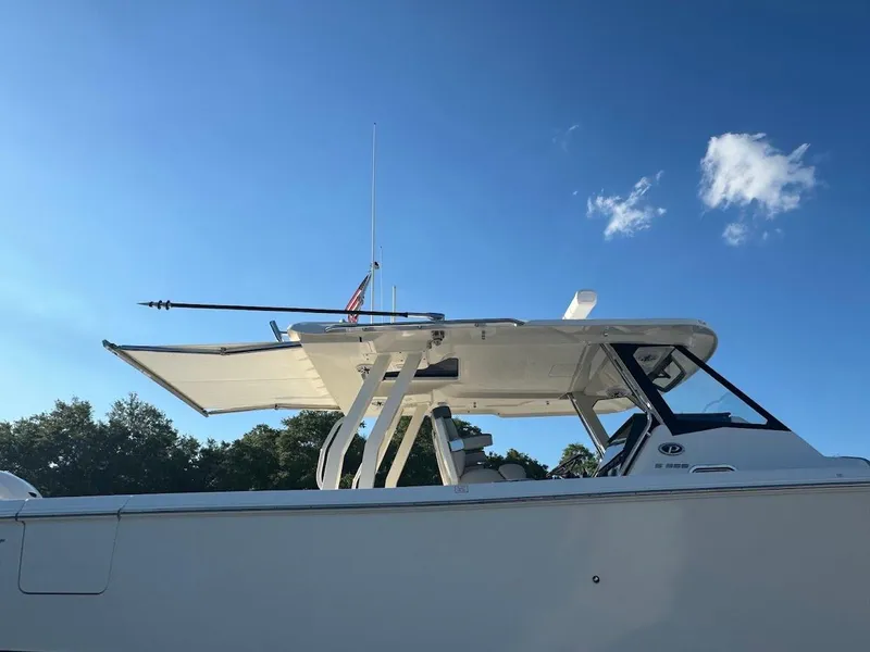 Slide: The Image of 2024 Pursuit S 358 Sport boat under clear blue sky. - 28