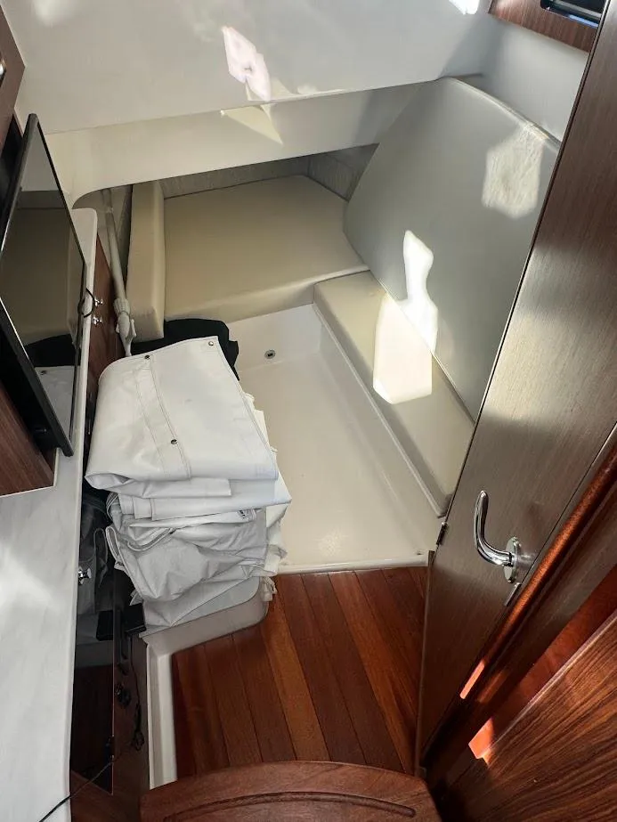 Slide: The Image of 2024 Pursuit S 358 Sport cabin interior with wooden flooring and seating area. - 35