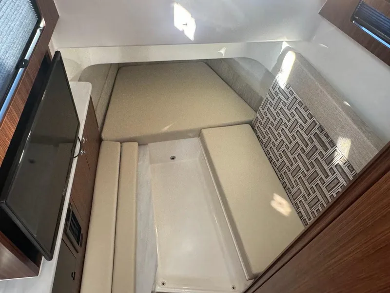 Slide: The Image of 2024 Pursuit S 358 Sport cabin interior with cushioned seating and patterned wall design. - 38