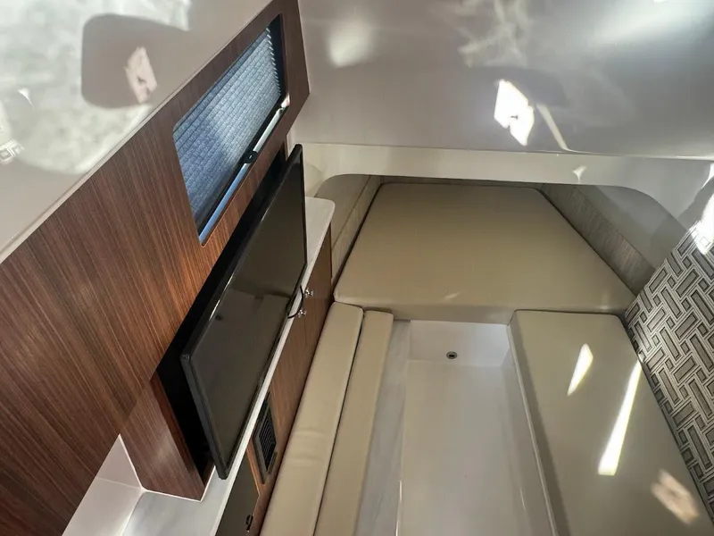 Slide: The Image of 2024 Pursuit S 358 Sport cabin interior with TV and seating area. - 39