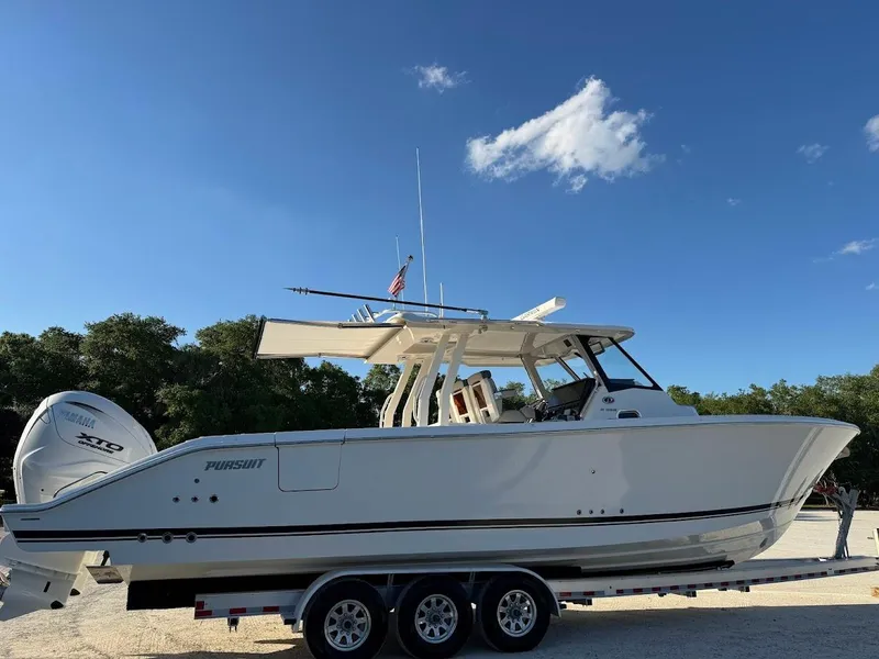 Slide: The Image of 2024 Pursuit S 358 Sport boat on trailer under clear blue sky. - 4