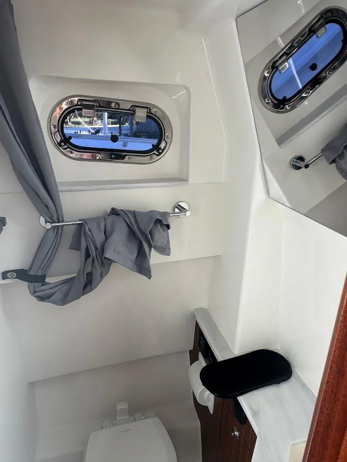 Slide: The Image of 2024 Pursuit S 358 Sport boat interior with porthole and modern amenities. - 40