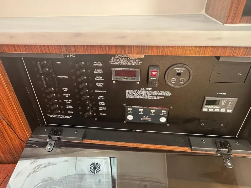 Slide: The Image of Control panel of 2024 Pursuit S 358 Sport boat, featuring various switches and displays. - 42