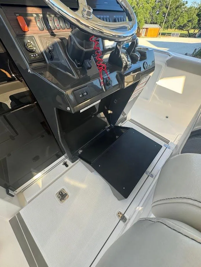 Slide: The Image of 2024 Pursuit S 358 Sport boat dashboard with steering wheel and control panel. - 45