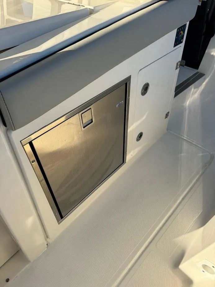 Slide: The Image of 2024 Pursuit S 358 Sport boat interior with stainless steel storage compartment. - 49