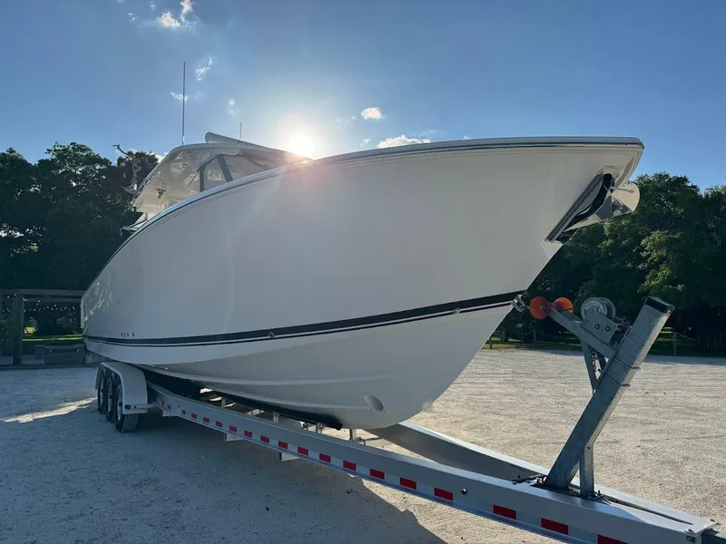 Slide: The Image of 2024 Pursuit S 358 Sport boat on trailer under clear blue sky. - 8