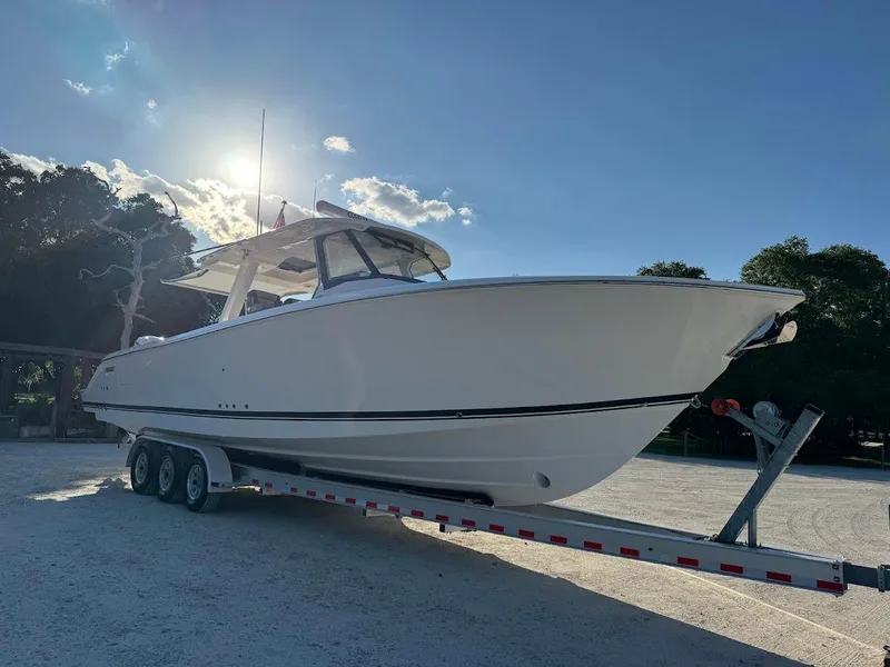 Slide: The Image of 2024 Pursuit S 358 Sport boat on trailer under clear sky. - 9
